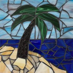 a stained glass window with a palm tree