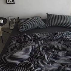 a bed with black and white striped sheets