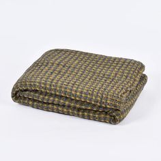 a brown and black checkered blanket on a white background