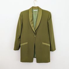 Women's size Au 12 90s vintage blazer by Teena Varigos in vibrant leaf green. Satin collar and fully lined. Mid thigh length, and shoulder pads. A real statement piece. Made in Australia. Polyester Excellent condition Pictured on a size Au8 mannequin. Marked size 16, but fits more like size 12. Measures laid flat- 54cm chest/ 83cm length/ 43cm between the shoulders at the back. Disclaimer: Please keep in mind these are vintage/preloved items and may show signs of wear.  I do my very best to find Green Notch Lapel Blazer For Evening, Tailored Green Evening Blazer, Tailored Green Blazer For Evening, Fitted Green Blazer For Evening, Green Fitted Evening Blazer, Fitted Green Evening Blazer, Retro Green Formal Outerwear, Green Evening Blazer For Fall, Retro Green Blazer For Work