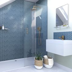 a modern bathroom with blue tile and white fixtures, including a walk - in shower