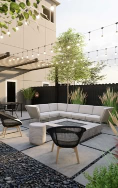 an outdoor living area with furniture and lights