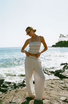 FINAL SALE. Elevate your warm weather wardrobe with the Vero Woven Smocked Tank Pants Set. This matching set features smocked detailing with contrasting stitching, adding a touch of effortless to your look. Chic Cotton Smocked Top For Beach, Summer Cotton Smocked Top With Elastic Waistband, Summer Smocked Cotton Top With Elastic Waistband, Cotton Smocked Top With Smocked Cuffs For Vacation, Cropped Cotton Bottoms For Vacation, Casual Smocked Top For Beach, Casual Smocked Top With Smocked Cuffs For Vacation, Casual Smocked Top With Smocked Cuffs For Beach, Summer Bottoms With Smocked Back For Daywear