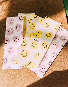 three envelopes with smiley faces on them