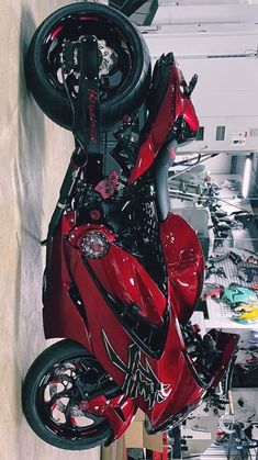 a red motorcycle parked inside of a garage