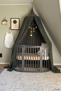 a baby crib in the corner of a room with a canopy over it's bed