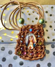 a necklace with an image of the virgin mary on it and some beads around it