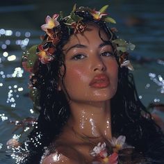 a woman with flowers in her hair swims in the water