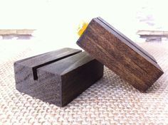 two small wooden boxes sitting on top of a white cloth covered table next to each other