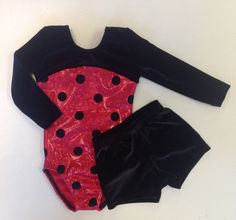 a red and black outfit with polka dots on it