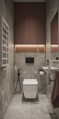 a bathroom with a toilet, sink and towel rack on the wall next to it