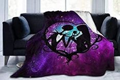 a purple and blue blanket with an image of a couple kissing under the moon in space