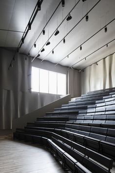 an empty auditorium filled with black seats