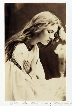 an old black and white photo of a woman with her hands on her chest looking down