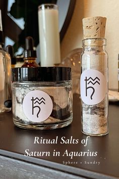 two jars filled with salt sit on top of a table