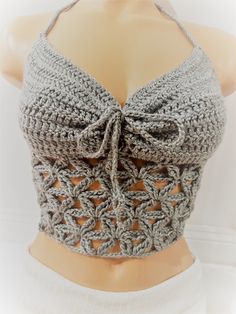 a crocheted top is shown on a mannequin's headpiece