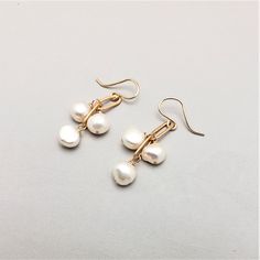 Three stones dangle from brass chain.  Great for all ages, these simple earrings are easily dressed up or down.     All pieces will be packaged together in a cotton filled jewelry box unless otherwise specified. Please let us know if your order is a gift and we will gladly include a handwritten note and complimentary g Dainty Metal Drop Pearl Earrings, Handmade White Pearl Earrings In 14k Gold Filled, White Gold Plated Dangle Jewelry, Handmade White Gold-plated Earrings, Delicate Brass Jewelry For Gifts, Hypoallergenic Metal Wedding Earrings, Hypoallergenic Metal Earrings For Wedding, Classic Metal Jewelry With Pearl Drop, Handmade Dangle Pearl Earrings In 14k Gold Filled