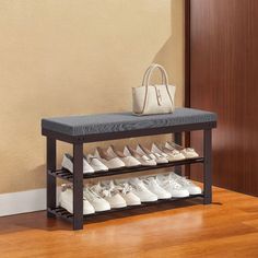 there is a shoe rack with many pairs of shoes on it and a handbag next to it