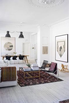 a living room filled with lots of furniture and pictures on the wall next to each other