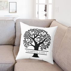 a family tree pillow sitting on top of a couch