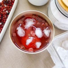 a bowl filled with ice and water next to other food