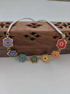 a colorful beaded bracelet on top of a piece of wood