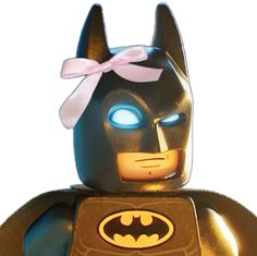 the lego batman movie character has blue eyes and a pink bow on his head,