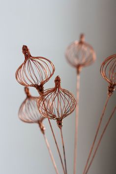 three wire sculptures sitting on top of each other