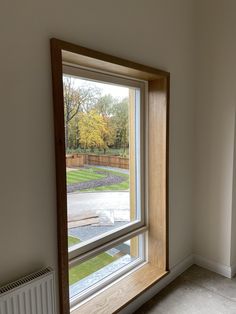 an empty room with a large window on the wall and a radiator next to it