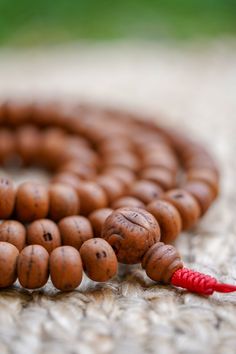 "Bodhi seed beads can be used for counting all types of mantras as well as other prayers.  These dark-speckled seed beads have special meaning for all seekers of divine wisdom.  \"Bodhi\" in Sanskrit means enlightenment; as an \"enlightened\" seed, many practitioners use these malas for their essence and inherent teachings within each seed.  Product Specification: *Material: Bodhi Seed from Nepal *Hand Strung: Yes *Size of Guru Bead: 12 -13 mm Approx. *Bead Quantity: 108 Beads Pcs *Length of Pra Spiritual Wooden Beads For Puja, Brown Mala With 8mm Beads For Puja, Spiritual Wooden Beads Mala For Puja, Traditional Mala With Round Beads For Blessing, Traditional Round Beads Mala For Blessing, Adjustable Mala With 8mm Beads For Blessing, Brown Mala With Round Beads For Puja, Brown Round Beads Mala For Puja, Spiritual Round Beads Mala For Puja