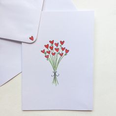 a bouquet of red hearts on a white envelope