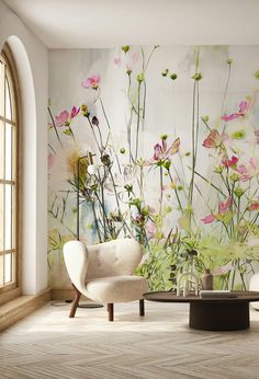 a living room with flowers painted on the wall and a chair in front of it