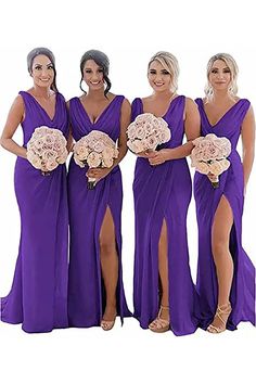 four bridesmaids in purple dresses posing for the camera with their bouquets on