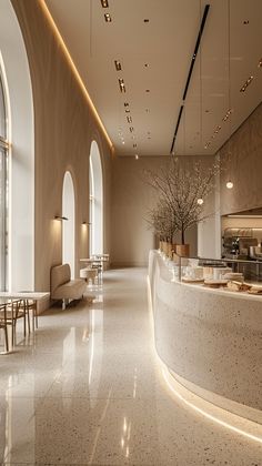 the interior of a large building with high ceilings and white marble flooring is lit by recessed lights