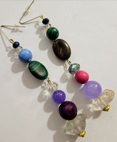 4.5" in length; comfortable and lightweight. Please note that the design is identical on both earrings, but the actual beads differ. I ran out of matching beads so I decided to continue even though the components differ. The components include the following: faceted double terminated quartz, agate, faceted crystals, malachite, porcelain, fuchsia magnesite and crazy lace agate. All the components are strung on wires and then suspended from an ear wire with a silicone back to prevent loss. If you prefer a "fish-hook" style wire, I can swap it out for either gold or silver tone 925 sterling silver (free of charge). OOAK Wearable Art from the Atelier of Kat Kouture! (priced accordingly given the mismatch) Dangle Beaded Earrings With Gemstone Beads For Jewelry Making, Gemstone Beaded Dangle Earrings For Jewelry Making, Gemstone Beads Dangle Earrings For Jewelry Making, Elegant Multicolor Beaded Crystal Earrings, Bohemian Drop Earrings With Gemstone Beads, Multicolor Beaded Crystal Earrings, Multicolor Beaded Dangle Crystal Earrings, Multicolor Crystal Dangle Earrings With Colorful Beads, Multicolor Crystal Earrings With Dangling Round Beads