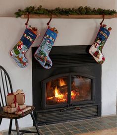 two stockings hanging over a fireplace with presents