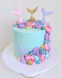 a blue cake with pink and purple decorations