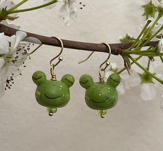 Ribbit ribbit! These smiling frog earrings are made with glass beads and 14k gold-plated hypoallergenic ear wires so that everyone can enjoy these amphibians. They also come with squishy, clear rubber backs to make sure they don't fall out. These earrings are made to order and there is some variation in the glass frog's smile/ eyes. Frog Fashion, Smile Eyes, Frog Earrings, Glass Frog, Virginia Beach, Amphibians, Ear Wires, Jewelry Earrings Dangle, Etsy Earrings