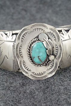 This amazing turquoise and sterling silver bracelet featuring horses and a hat a with feather in the brim was made by Navajo silversmith Tim Yazzie. The back is signed T Yazzie and stamped sterling.Size: 5 5/8" (will fit up to a 6 7/8" wrist)Gap: 1 1/4"Width: 1 5/8"Free shipping on all orders! We ship with USPS and always include tracking. All orders ship within a day of payment.Returns are accepted up to 30 days after you receive your order. Just send us a message. Our shop offers cash back or Western Style Engraved Jewelry For Rodeo, Western Engraved Jewelry For Rodeo, Artisan Silver Jewelry For Rodeo, Vintage Adjustable Turquoise Sterling Silver Bracelet, Adjustable Western Sterling Silver Bracelet For Gift, Engraved Silver Jewelry For Rodeo, Western Sterling Silver Cuff Bracelet, Western Sterling Silver Bracelets, Western Style Sterling Silver Cuff Bracelet