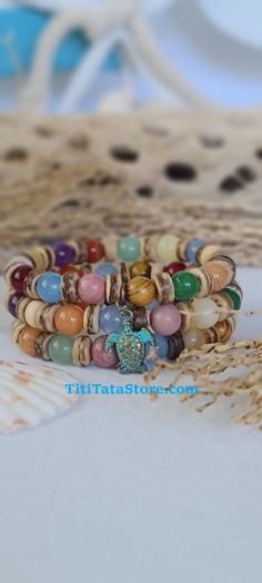 TitiTataStore.com Always FREE SHIPPING and a FREE GIFT! I Will Ship Within 24 Hours! Description: This listing is for A Set of Three Handmade Tropical Style Bracelets.  A Multicolor Summer Beach Bracelets Delight!   Materials: 8mm Natural Gemstones, 8mm Wood Beads, and Coconut Shells Beads. A lovely Sea Turtle adorned this beachy set.  Every Bracelet in my shop is handmade by me using high quality materials. A high-quality elastic stretch cord is used to string the beads together. Size: Each bra Multicolor Beaded Bracelets For Beach Season Gift, Spiritual Friendship Bracelets With Round Beads For Beach, Multicolor Hippie Bracelets For Vacation, Beachy Multicolor Friendship Bracelets For Vacation, Multicolor Beaded Bracelets For Beach, Multicolor Tropical Jewelry For Beach, Colorful Hippie Beach Jewelry, Tropical Style Multicolor Jewelry For Beach, Tropical Multicolor Beach Jewelry