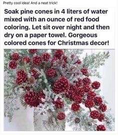 a vase filled with lots of red flowers next to a christmas decoration on top of a table