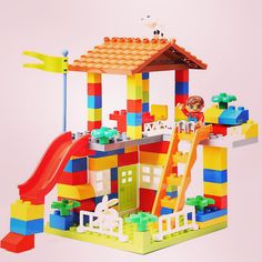 a toy house made out of legos with a slide and play set in the front