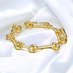 "Indulge in the elegance of our Paperclip Link Chain bracelet, adorned with a luscious yellow coating that exudes luxury. Elevate your style effortlessly by pairing this exquisite bracelet with your cherished outfits, making it an essential addition to your wardrobe. For the ultimate lavish ensemble, complement it with our Paperclip Chain Necklace and embrace a truly opulent look. 18K Yellow Gold Plated 8\" or 20cm 29g Hook in clasp Link to necklace: https://www.etsy.com/listing/1546766597/paperclip-style-wlarge-open-oval-links?click_key=2c5a21297b60a620a8977ea342664e03bd452097%3A1546766597&click_sum=b58b85b7&ref=shop_home_active_2&frs=1" Luxury Gold-tone Oval Link Paperclip Bracelet, Luxury Oval Link Bracelet With Clasp, Luxury Gold Plated Chain Bracelet With Oval Link, Luxury Gold-tone Link Jewelry, Paperclip Chain Necklace, Link Chain Bracelet, Trombone, Lovely Earrings, Chain Link Bracelet