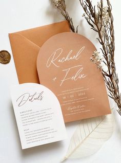 the wedding stationery is displayed on top of an envelope