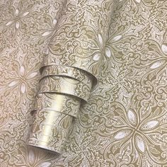 a roll of metallic foil sitting on top of a table