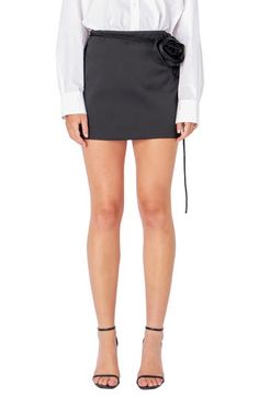 A dimensional floral detail adds a pop of modern romance to this smooth satin skort in a mini length. Hidden side-zip closure Attached waist tie Lined 100% polyester Hand wash, dry flat Imported Chic Fitted Mini Skirt With Tie Waist, Elegant Short Skort For Party, Chic Mini Skort With Tie Waist, Chic Evening Skort In Short Length, Chic Mini Skirt With Tie Waist, Short Length Skort With Tie Waist, Elegant Mini Skirt With Tie Waist, Chic Mini-length Bottoms With Tie Waist, Chic Tie Waist Mini Bottoms