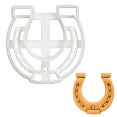 a white and orange object next to a pair of horseshoes on a white background