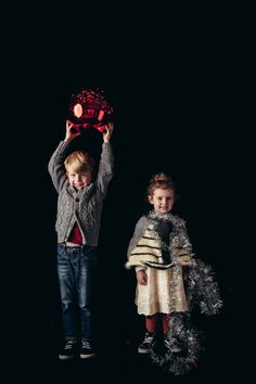 two small children holding up a red object