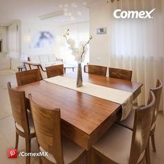 a dining room table and chairs in front of a window with the word comex on it