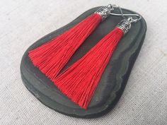 "Chic red tassel earrings! They would add a pop of color to any outfit for any occasion. Dress them up or down. They are timeless and versatile. They are lightweight, fun and unique! The tassels measure 2 1/8\" long by 1/4\" wide. They hang from simple silver ear wire hooks. Overall drop length is about 2 1/4\". Metal is allergy free plated silver. These are my latest creation! I have them available in many colors! Find them all under the category tassel earrings in my shop. Thanks for stopping Red Dangle Tassel Earrings As Gift, Red Fringe Tassel Earrings As Gift, Red Tassel Earrings With Fringe For Gift, Red Tassel Drop Earrings Gift, Red Tassel Earrings For Gift, Red Dangle Tassel Earrings For Gift, Red Fringe Tassel Earrings For Gift, Cheap Handmade Red Tassel Earrings, Red Statement Earrings